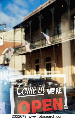Stock Photo - USA, Louisiana, French Quarter; New Orleans, Traditional building reflected in shop window. Fotosearch