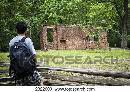 Stock Photo - USA, Mississippi, Natchez Trace Parkway; Natchez, Tourist looking at Elizabeth Female Academy ruins. Fotosearch