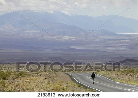 Usa, Nevada Border, California, Route 374; Death Valley National Park, Highway 374, Young Woman Standing On Deserted Road In Desert View Large Photo Image Stock Image - Usa, Nevada Border, California, Route 374; Death Valley National Park, Highway 374, Young Woman Standing On Deserted Road In Desert. Fotosearch
