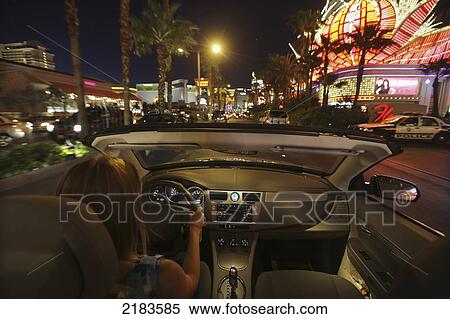 Stock Photography - Usa, Nevada, Young Woman Driving Her Convertible Car Down Las Vegas Boulevard ( Strip ) In Las Vegas At Night Beneath Neon Lights; Las Vegas. Fotosearch