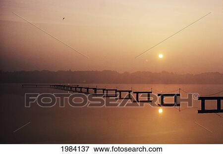 USA, New Jersey, Sunrise over inland waterway with reflections in smooth water; Cape May View Large Photo Image Stock Photo - USA, New Jersey, Sunrise over inland waterway with reflections in smooth water; Cape May. Fotosearch