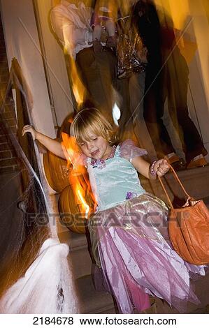 Stock Photo - Usa, New York State, Girl In Halloween Costume Walking Down Stairs; New York City. Fotosearch