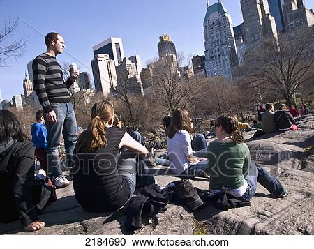 Stock Image - Usa, New York State, Group Of People Relaxing In Central Park; New York City. Fotosearch