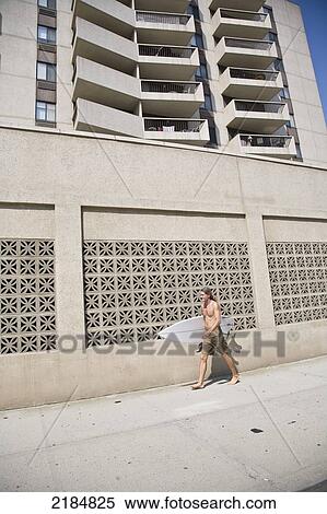Usa, New York State, Man Walking With Surfboard By Hotel; Long Beach View Large Photo Image Stock Photography - Usa, New York State, Man Walking With Surfboard By Hotel; Long Beach. Fotosearch