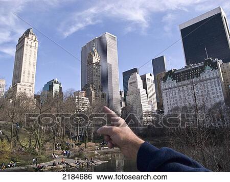 Stock Photograph - Usa, New York State, New York City, Arm Pointing At Building; Central Park. Fotosearch
