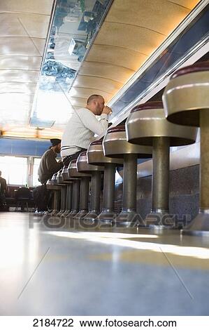 Stock Image - Usa, New York State, New York City, Brooklyn, Men Eating Cheeseburgers At Relish Diner; Williamsburg. Fotosearch