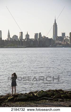 Usa, New York State, New York City, Williamsburg, Summer Pool Party; East River Park, East River, Woman Taking Photo Of Cityscape View Large Photo Image Stock Image - Usa, New York State, New York City, Williamsburg, Summer Pool Party; East River Park, East River, Woman Taking Photo Of Cityscape. Fotosearch