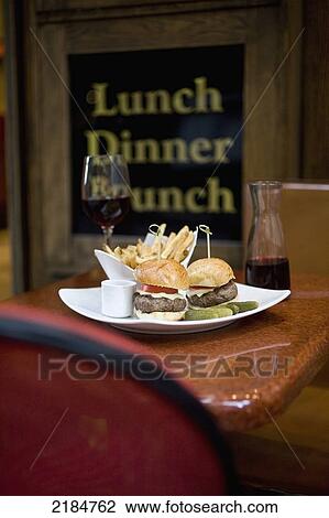 Stock Image - Usa, New York State, Plate Of Fries And Hamburgers In Cinema Restaurant; New York City. Fotosearch