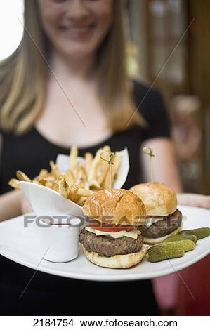 Picture - Usa, New York State, Waitress With Fries And Hamburger In Cinema Restaurant; New York City. Fotosearch