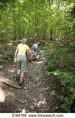 Stock Photo - Usa, New York State, Woman And Child Trekking In Forest; Hudson Valley. Fotosearch
