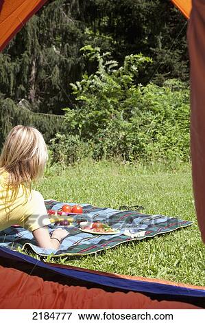Stock Photo - Usa, New York State, Woman Laying On Picnic Blanket; Hudson Valley. Fotosearch