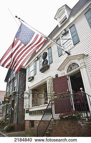Stock Image - Usa, Rhode Island, Bannister's Wharf; Newport, Restaurant With Us Flag Above Doors. Fotosearch