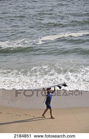 Usa, Rhode Island, Boy Walking Beach Carrying Surfboard On Head; Newport View Large Photo Image Stock Image - Usa, Rhode Island, Boy Walking Beach Carrying Surfboard On Head; Newport. Fotosearch