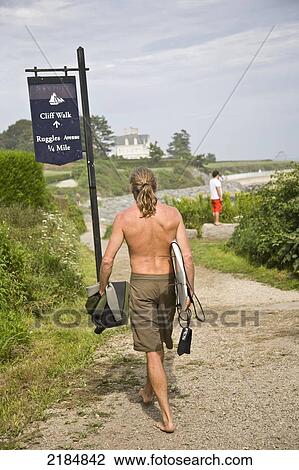 Stock Image - Usa, Rhode Island, Newport, Rear View; Ruggles, Man Heading To Beach. Fotosearch