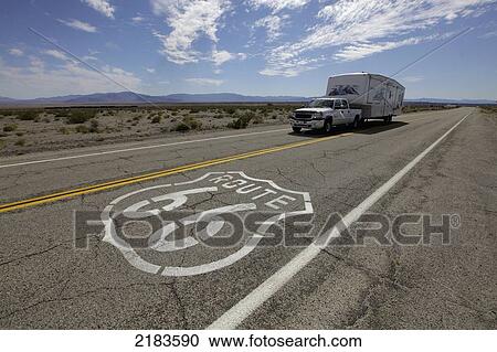 Stock Image - Usa, Rv Driving Through Desert Along Route 66; California. Fotosearch