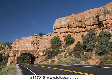 Stock Photography - USA, Utah, Dixie National Forest, Red Canyon, Claron Limestone Formations, Tunnel cut through rock formation for road.. Fotosearch