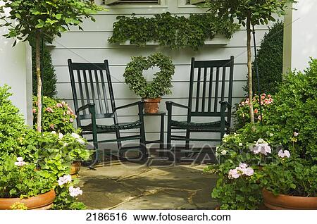USA, Virginia, Wooden rocking chairs at the English style garden at the private home of Mary Beth Wood. Just one of many properities open during The Historic Garden Week in Virginia. America's Oldest and largest House and Garden Tour; Winchester View Large Photo Image Stock Photograph - USA, Virginia, Wooden rocking chairs at the English style garden at the private home of Mary Beth Wood. Just one of many properities open during The Historic Garden Week in Virginia. America's Oldest and largest House and Garden Tour; Winchester. Fotosearch