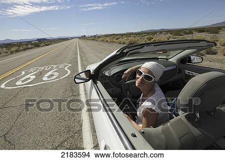 Usa, Young Woman Driving Her Convertible Car Through Desert Along Route 66; California View Large Photo Image Picture - Usa, Young Woman Driving Her Convertible Car Through Desert Along Route 66; California. Fotosearch