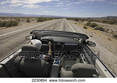 Usa, Young Woman Driving Her Convertible Car Through Desert Along Route 66; California View Large Photo Image Picture - Usa, Young Woman Driving Her Convertible Car Through Desert Along Route 66; California. Fotosearch