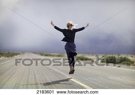 Usa, Young Woman Jumping In Deserted Road On Highway 190; California View Large Photo Image Stock Image - Usa, Young Woman Jumping In Deserted Road On Highway 190; California. Fotosearch