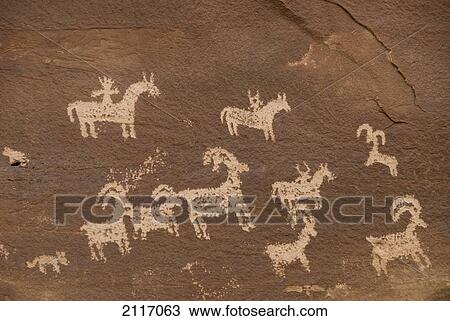 Stock Image - Utah, Arches National Park, Ancient Petroglyphs depicting animals on rock.. Fotosearch