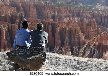 Stock Photo - Utah. Middle Age Couple Viewing The Hoodoos From Inspiration Point At Bryce Canyon. Doug Mckinlay/Axiom. Fotosearch