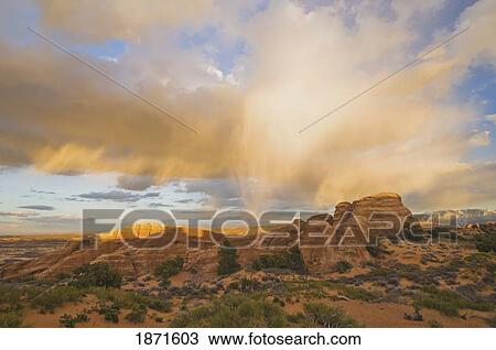 Stock Image - Utah, United States Of America; A Clearing Storm Over Sandstone Formations At Sunset In Arches National Park. Fotosearch