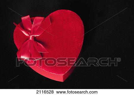 Valentines heart-shaped candy box against black background. View Large Photo Image Stock Photo - Valentines heart-shaped candy box against black background.. Fotosearch