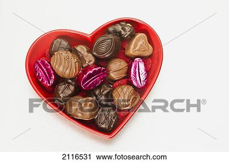 Stock Image - Valentines heart-shaped tray with assortment of sweets.. Fotosearch