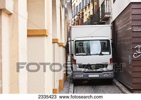 Stock Image - Van In Narrow Street; Seville, Andalucia, Spain, Europe. Fotosearch