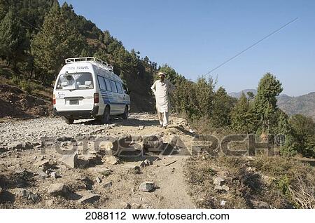 Stock Image - Van On A Road Damaged By The 8 October 2005 Earthquake, Chikar To Saran Road, Azad Kashmir, Pakistan. Fotosearch