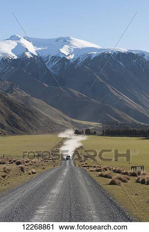 Vehicle driving on the Double Hill Run Road with scenic mountains in the background, Methven, New Zealand View Large Photo Image Stock Image - Vehicle driving on the Double Hill Run Road with scenic mountains in the background, Methven, New Zealand. Fotosearch