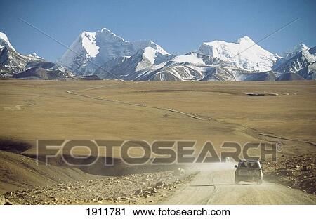 Stock Image - Vehicle On Dirt Road Through Himalayas, Tibet. Fotosearch