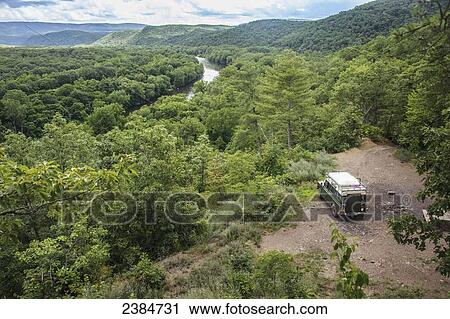 Stock Image - Vehicle sitting in a remote treed area with the C&O canal and Potomac river in the background, Green Ridge State Forest; Flintstone, Maryland, United States of America. Fotosearch