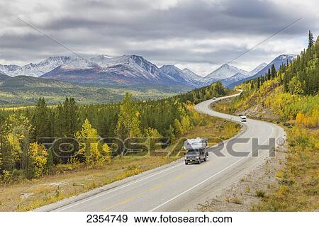 Stock Photo - Vehicles Travel The Winding Al-Can Highway That Connects Alaska With Canada Via Road; Yukon Territory, Canada. Fotosearch
