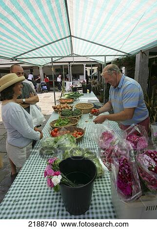 Vendor and shoppers at the Dartmouth Farmers Market; Dartmouth, Devon, England View Large Photo Image Stock Image - Vendor and shoppers at the Dartmouth Farmers Market; Dartmouth, Devon, England. Fotosearch
