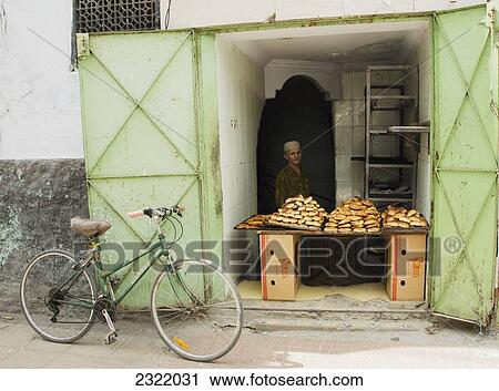 Vendor selling bread with bicycle outside shop; Old Medina, Casablanca, Morocco View Large Photo Image Stock Image - Vendor selling bread with bicycle outside shop; Old Medina, Casablanca, Morocco. Fotosearch