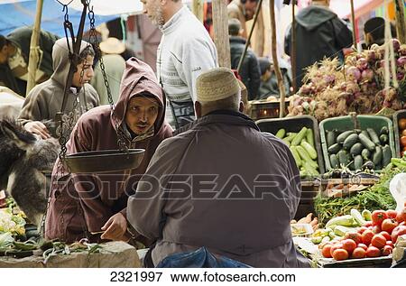 Vendors and shoppers at fresh food market; Morocco View Large Photo Image Stock Photo - Vendors and shoppers at fresh food market; Morocco. Fotosearch