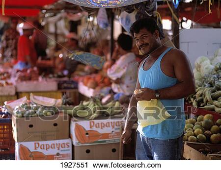 Stock Image - Venezuelan Trader In Floating Market. Fotosearch