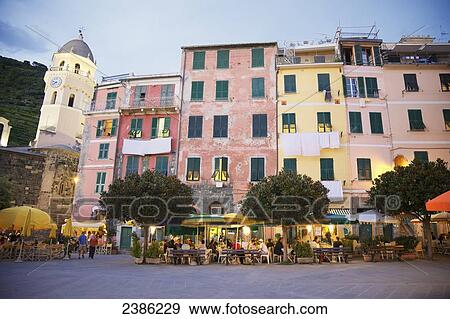 Stock Photo - Vernazza waterfront and Santa Margherita d'Antiochia Church at dusk, Cinque Terre; Vernazza, La Spezia, Liguria, Italy. Fotosearch