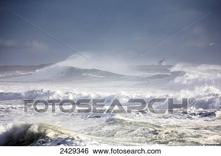 Stock Photograph - Very rough Atlantic Ocean waves with small Icelandic church in the background, near the Blue Lagoon and number 1 highway; Iceland. Fotosearch