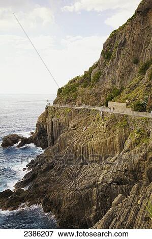 Via dell'Amore path and coastline; Riomaggiore, La Spezia, Liguria, Italy View Large Photo Image Stock Photo - Via dell'Amore path and coastline; Riomaggiore, La Spezia, Liguria, Italy. Fotosearch