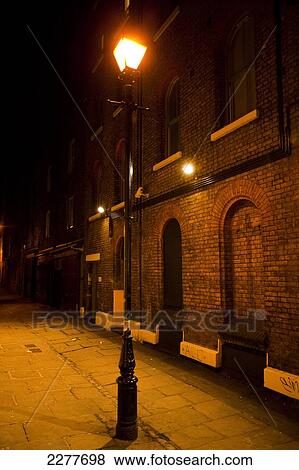 Victorian street lamp lights streets of East London at night; London, England View Large Photo Image Stock Photo - Victorian street lamp lights streets of East London at night; London, England. Fotosearch