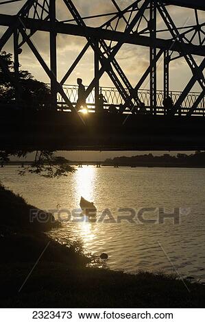 Stock Image - Vietnam, Man Crossing Trang Tien Bridge On Perfume River; Hue. Fotosearch