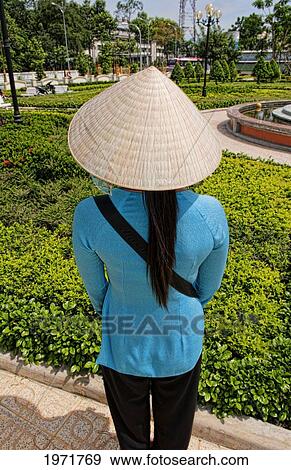 Stock Photo - Vietnam, Saigon, Ho Chi Minh, Portrait Of A Young Vietnamese Woman In Traditional Clothing, From Behind.. Fotosearch
