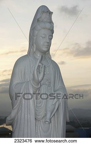 Stock Photograph - Vietnam, Statue Of The Goddess Of Mercy (Guanyin) At Sunset; Hue. Fotosearch