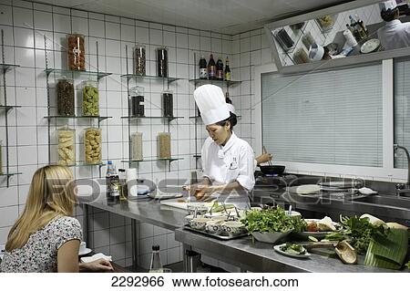 Stock Photograph - Vietnam, Tourist with chef at market Metropole Hotel Cookery School; Hanoi. Fotosearch