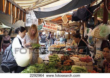 Vietnam, Tourist with cook at market Metropole Hotel Cookery School; Hanoi View Large Photo Image Picture - Vietnam, Tourist with cook at market Metropole Hotel Cookery School; Hanoi. Fotosearch