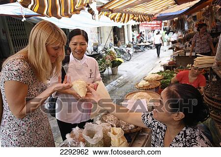 Vietnam, Tourist with cook at market Metropole Hotel Cookery School; Hanoi View Large Photo Image Stock Image - Vietnam, Tourist with cook at market Metropole Hotel Cookery School; Hanoi. Fotosearch