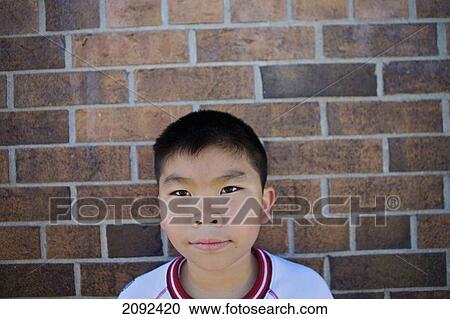 Vietnamese Boy Against Brick Wall Of An Esl School; Guelph Ontario Canada View Large Photo Image Stock Image - Vietnamese Boy Against Brick Wall Of An Esl School; Guelph Ontario Canada. Fotosearch